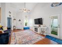 Bright living room with vaulted ceilings, hardwood floors, modern fireplace, and lots of natural light at 1602 Buckingham Place Pl, Woodstock, GA 30188