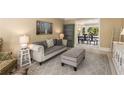 Comfortable living room with neutral hues and open view into the dining area at 7575 Hunters Woods W Dr, Atlanta, GA 30350