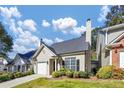 Charming home with manicured lawn, features an attached garage, neutral color scheme, and appealing architectural details at 1338 Gates Se Dr, Atlanta, GA 30316