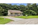 Home exterior with neutral siding, gray trim, front lawn, and a long driveway at 35 Ravenwood Dr, Rockmart, GA 30153
