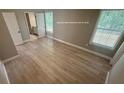 A light-filled main bedroom featuring light wood floors, and an en suite bathroom at 1090 Coleman Sw St, Atlanta, GA 30310