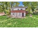 Two-story home's back exterior with brick and siding, set in a lush, green backyard at 2991 Monterey Drive Dr, Decatur, GA 30032