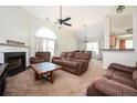 Inviting living room featuring a cozy fireplace, plush brown furniture, and a high ceiling at 4776 Harrod Ct, Douglasville, GA 30135