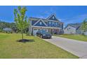 Two-story home with a manicured lawn and a paved driveway at 611 Sugar Prairie Bnd, Lawrenceville, GA 30045