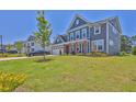 Two-story home with a manicured lawn and a paved driveway at 611 Sugar Prairie Bnd, Lawrenceville, GA 30045