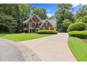 Beautiful two-story brick home with well-maintained lawn and long driveway at 15 Vickwood Court Ne, Marietta, GA 30068
