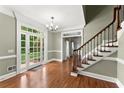 Elegant foyer with hardwood floors, grand staircase, and French doors at 15 Vickwood Court Ne, Marietta, GA 30068