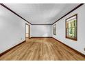Bright living room features hardwood flooring, neutral walls, and natural light through well-placed windows at 2775 Doaks Run Ct, Tucker, GA 30084