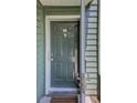 A close up view of the front door, showing the unit number, door knocker, handles, and the security lock at 4604 Vinings Central Se Run # 131, Atlanta, GA 30339
