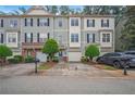 Attractive townhome showcasing the front exterior with an attached garage and lush landscaping at 1768 Oakbrook Nw Ln # 9, Kennesaw, GA 30152