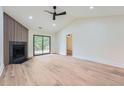 Bright living room features a fireplace, vaulted ceiling, and sliding glass door to the backyard at 2027 Jebs Nw Ct, Kennesaw, GA 30144