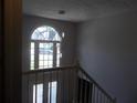 Bright entryway with a two-story foyer, large arched window, and modern pendant lighting at 4125 Fastnet Lane, Duluth, GA 30096