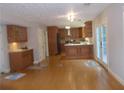 An open-concept kitchen featuring custom wood cabinets and a butcher block island with hardwood floors at 4125 Fastnet Lane, Duluth, GA 30096