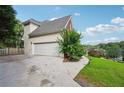 Spacious driveway leading to a two-car garage, showcasing the home's exterior and landscaping at 10119 Azalea Dr, Covington, GA 30014