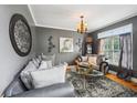 Cozy living room with hardwood floors, stylish furnishings, and a large window at 10119 Azalea Dr, Covington, GA 30014