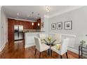 Cozy dining area featuring hardwood floors, modern lighting, and a glass-top table with seating at 1403 Ashford Creek Ne Cir, Atlanta, GA 30319