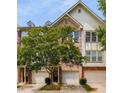 Charming brick townhome exterior featuring a single-car garage and lush shade tree at 1403 Ashford Creek Ne Cir, Atlanta, GA 30319