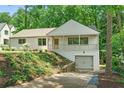 Attractive single-story house with front porch, garage, and lovely landscaping at 4103 Statewood Ne Rd, Atlanta, GA 30342