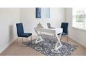 Bright office space with modern white desk, blue chairs, and large patterned area rug at 133 Bandimere Pkwy, Dallas, GA 30157