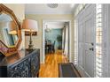 Inviting foyer with hardwood floors, a decorative mirror, and a view into the dining room at 5130 Stoneywood Se Cir, Mableton, GA 30126