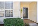 Close-up of a front door with decorative plants and a 'welcome' mat at 134 Odyssey Turn, Conyers, GA 30012