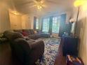 Spacious living room features a large sectional sofa and a large window at 134 Odyssey Turn, Conyers, GA 30012