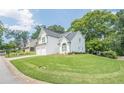 Charming two-story home with white brick and siding, attached two-car garage, and well-maintained landscaping at 86 Whitlock Sw Sq, Marietta, GA 30064