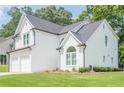 Charming two-story home with white brick and siding, attached two-car garage, and well-maintained landscaping at 86 Whitlock Sw Sq, Marietta, GA 30064