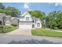 Charming two-story home with white brick and siding, attached two-car garage, and well-maintained landscaping at 86 Whitlock Sw Sq, Marietta, GA 30064