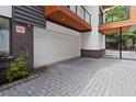 Private brick-paved driveway leading to a detached garage with wooden balconies above at 367 Parkway Ne Dr # 7, Atlanta, GA 30312