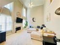 Spacious living room features a fireplace, tall windows, and modern decor at 5771 Vinings Retreat Sw Way, Mableton, GA 30126