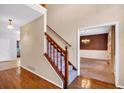 Foyer with hardwood floors with staircase and classic wallpaper at 5148 Coolamber Dr, Powder Springs, GA 30127