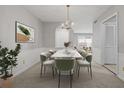 Refined dining room featuring an elegant chandelier, neutral wall colors, and modern furniture at 68 La Rue Nw Pl, Atlanta, GA 30327
