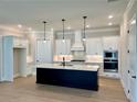Bright, modern kitchen with a center island, stainless steel appliances, and ample cabinet space at 7220 Winderlea Ln, Cumming, GA 30040