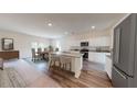 Open kitchen with island, granite countertops, stainless appliances, and adjacent dining area at 109 Bandimere Pkwy, Dallas, GA 30157