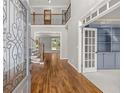 Inviting foyer with wood floors, staircase and front door with decorative glass insert and view of study at 4345 Mantle Ridge Dr, Cumming, GA 30041