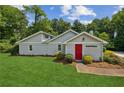 Attractive one-story home featuring a well-manicured lawn and inviting landscaping at 1480 Bettis Tribble Gap Rd, Cumming, GA 30040
