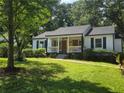 A charming home with a covered front porch and meticulously maintained lawn at 1617 Columbia Cir, Decatur, GA 30032