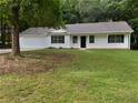Traditional home with attached garage and inviting front porch, set amidst a partially wooded lot at 230 Myrtle Grove Ln, Covington, GA 30014