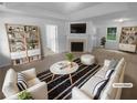 Bright living room with cozy fireplace, neutral decor, and stylish furnishings offers a comfortable living space at 230 Myrtle Grove Ln, Covington, GA 30014