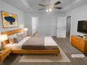 Serene main bedroom features a spacious layout with a ceiling fan and neutral tones for relaxation at 230 Myrtle Grove Ln, Covington, GA 30014