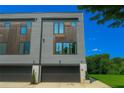 A modern home with a gray exterior and two-car garage against a blue sky at 2424 Memorial Drive Se Dr # 3, Atlanta, GA 30317