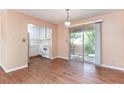 Bright dining area with wood-look flooring, sliding glass doors to the balcony, and an adjacent kitchen at 4266 Roswell Ne Rd # H4, Atlanta, GA 30342