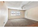 Spacious living room features neutral walls, carpeting, a ceiling fan, and large windows for natural light at 4266 Roswell Ne Rd # H4, Atlanta, GA 30342