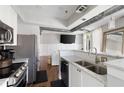 Bright kitchen featuring granite countertops, stainless steel appliances and an opening to the open-concept living area at 1029 Piedmont Ne Ave # 202, Atlanta, GA 30309