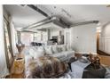 Stylish living room showcasing modern decor, open layout, and industrial-chic exposed ductwork and hardwood flooring at 1029 Piedmont Ne Ave # 202, Atlanta, GA 30309