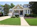 Charming home featuring a covered porch, neat landscaping, and an attached two-car garage at 126 Woodbury Ln, Canton, GA 30114