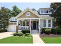 Charming home featuring a covered porch, neat landscaping, and an attached two-car garage at 126 Woodbury Ln, Canton, GA 30114
