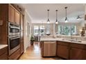 Modern kitchen with stainless steel appliances, wooden cabinets, and a breakfast bar, great for gatherings at 126 Woodbury Ln, Canton, GA 30114