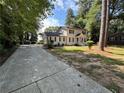 Two story home with a long driveway and a well-maintained lawn, offering a suburban feel at 1789 Springhouse Ct, Lawrenceville, GA 30043